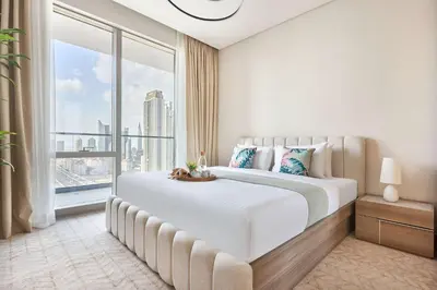 a bedroom with a large bed with a large window at Frank Porter - Vida Dubai Mall in Dubai