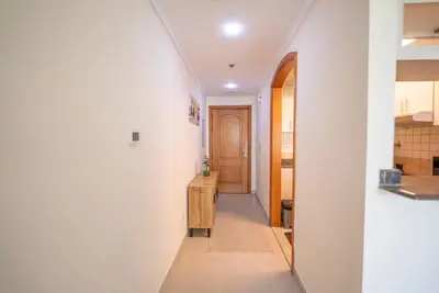 a hallway leading to a kitchen with a hallway leading to a room at Elegant Marina Living Manchester Tower in Dubai