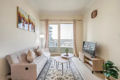 a living room with a couch and a tv at Elegant Marina Living Manchester Tower in Dubai
