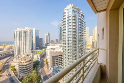 a view of a city from a balcony of a building at Elegant Marina Living Manchester Tower in Dubai