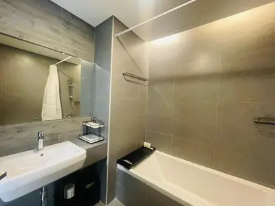 a bathroom with a sink and a bath tub at Vezul Residence, Business Bay - 2 Bedroom Apartment - Allsopp & Allsopp in Dubai