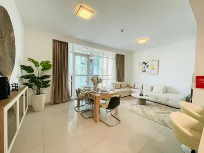 a living room with a table and a couch at Vezul Residence, Business Bay - 2 Bedroom Apartment - Allsopp & Allsopp in Dubai