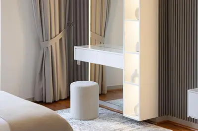 a bedroom with a bed and a table and a stool at Lux Unit Breathtaking Burj View I Walk Dubai Mall in Dubai