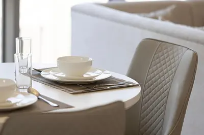 a table with a cup and a coffee cup on it at Lux Unit Breathtaking Burj View I Walk Dubai Mall in Dubai