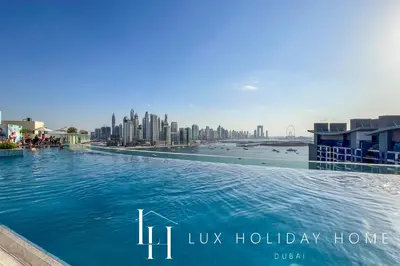 a large swimming pool with a city in the background at LUX The Seven Res Palm Suite in Dubai