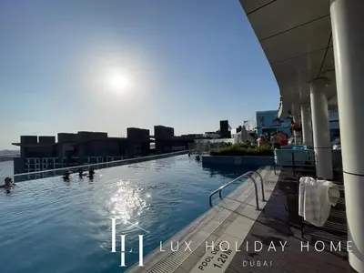 a swimming pool on the top of a building at LUX The Seven Res Palm Suite in Dubai
