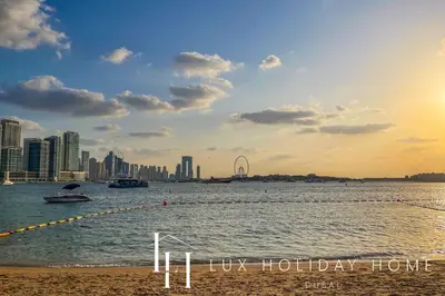 a body of water with a city in the background at LUX The Seven Res Palm Suite in Dubai