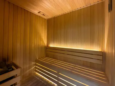 a sauna with a light on the inside of it at Sleek and Cozy Studio, Private Jacuzzi, Canal View in Dubai