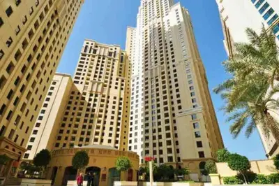 a group of tall white buildings in a city at Bright Apartment with Large Balcony and Water View in JBR in Dubai