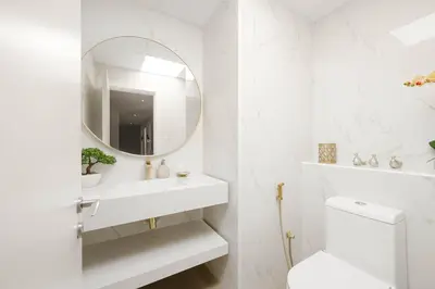 a white bathroom with a sink and a mirror at Bright Apartment with Large Balcony and Water View in JBR in Dubai
