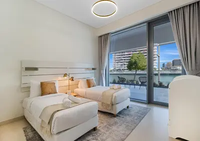a hotel room with two beds and a large window at Canal Front Residence 5, Al Wasl - 2 Bedroom with Maids room - Allsopp & Allsopp 02 in Dubai
