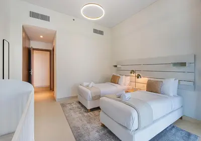 a hotel room with two beds and a couch at Canal Front Residence 5, Al Wasl - 2 Bedroom with Maids room - Allsopp & Allsopp 02 in Dubai