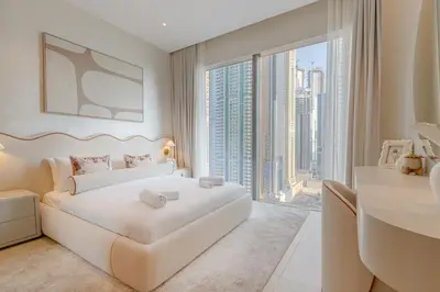 a bedroom with a large white bed and a large window at The Residences Marina Gate 1 - 2 Bedroom Apartment - Allsopp & Allsopp in Dubai