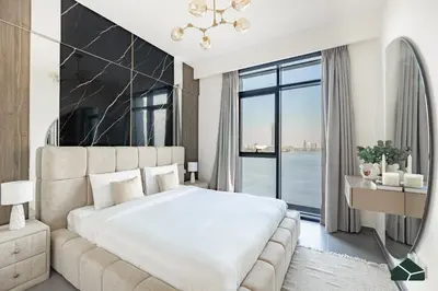 a bedroom with a large bed and a large window at Serene 2BR with Sea View by BMS in Dubai