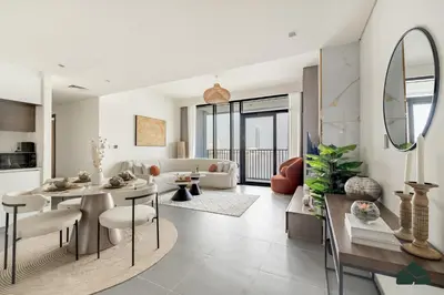 a white living room with a table and chairs at Serene 2BR with Sea View by BMS in Dubai