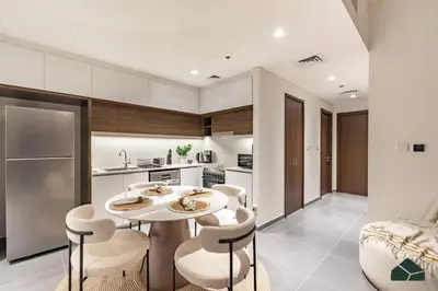 a kitchen with a table and chairs in a room at Serene 2BR with Sea View by BMS in Dubai