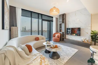 a living room with a white couch and a fireplace at Serene 2BR with Sea View by BMS in Dubai