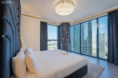 a bedroom with a large bed and large windows at Blvd Point-Full Burj Khalifa View-Downtown in Dubai