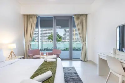 a white bedroom with a view of a city at Canal Front Residence 5, Al Wasl - 2 Bedroom with Maids room - Allsopp & Allsopp 01 in Dubai