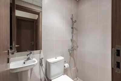 a bathroom with a toilet and a sink and a shower at Canal Front Residence 5, Al Wasl - 2 Bedroom with Maids room - Allsopp & Allsopp 01 in Dubai