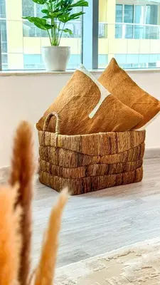 a basket on the floor with a potted plant at Stylish 1BDR Centrally Located for 4 Persons in Dubai