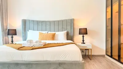 a bedroom with a bed with towels on it at Stylish 1BDR Centrally Located for 4 Persons in Dubai
