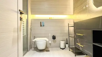 a small bathroom with a toilet and a sink at Stylish 1BDR Centrally Located for 4 Persons in Dubai