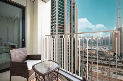 a balcony with a view of a city skyline at Modern 2BR, Burj & Fountains View, Dubai Mall 2 Minutes Walk in Dubai