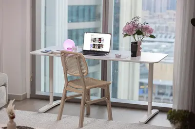 a desk with a laptop and a chair in a room at Modern 2BR, Burj & Fountains View, Dubai Mall 2 Minutes Walk in Dubai