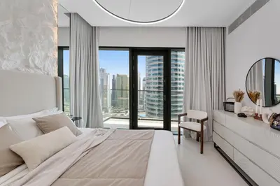 a white bedroom with a large bed and a window at VIDA Marina Best Location NEW in Dubai