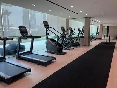 a gym with a row of treadmills in a building at Modern Studio JVC I Sleeps 3 I Fully Furnished in Dubai