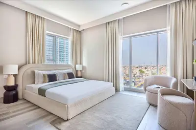 a bedroom with a bed and a large window at Frank Porter - Concept Residences in Dubai