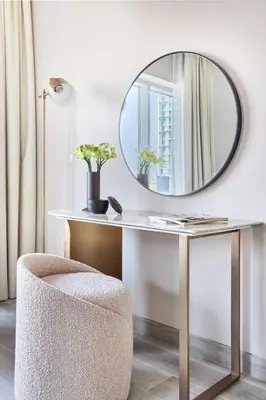 a dressing table with a mirror and a chair at Frank Porter - Concept Residences in Dubai