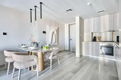 a kitchen and dining room with a table and chairs at Frank Porter - Concept Residences in Dubai