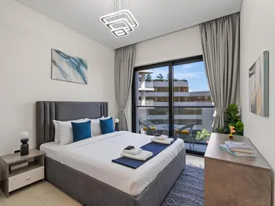 a bedroom with a large bed and a large window at Luxury 1BR Featuring Guest - Study Room-SOBHA Waves in Dubai