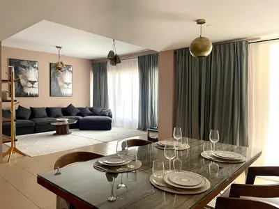 a living room with a table with wine glasses on it at Specious apartment in Sadaf 7 with Marina Views and Beach Access in Dubai