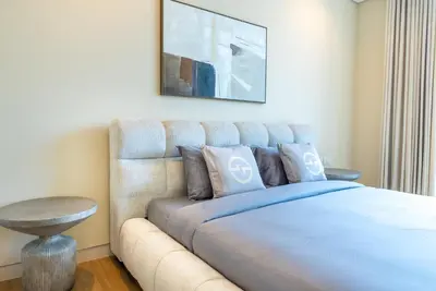 a bedroom with a large bed with a couch at Exquisite Jumeirah Bay Island Retreat 3 BR plus maids room in Dubai