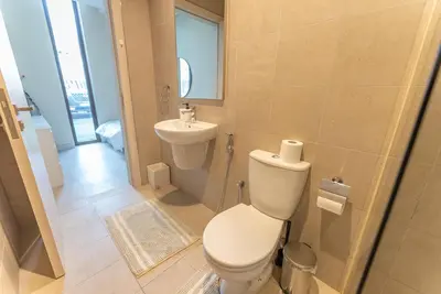 a bathroom with a toilet and a sink at Exquisite Jumeirah Bay Island Retreat 3 BR plus maids room in Dubai
