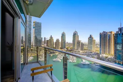 a balcony with a view of the water and boats at Stunning 1BR Apartment with Breathtaking Marina Views in Dubai