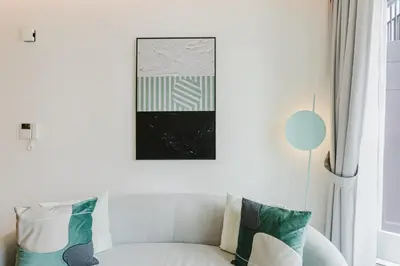 a living room with a white couch with pillows at RH- Premium Furnished Living in Business Bay near to Burj Khalifa in Dubai