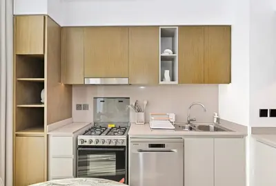 a kitchen with a stove and a sink at Golden Stays - Tranquil 4BR Villa with Pool & Coastal Charms in Dubai