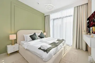 a bedroom with a large white bed and a window at Golden Stays - Tranquil 4BR Villa with Pool & Coastal Charms in Dubai