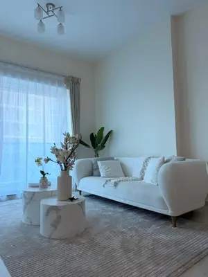 a living room with a white couch and a window at Orchid residence 1BHK apartment in Dubai