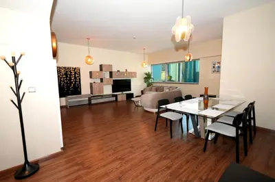 a dining room and living room with a table and chairs at Signature Luxury 2Bedroom Burj Khalifa Fountain View in Dubai