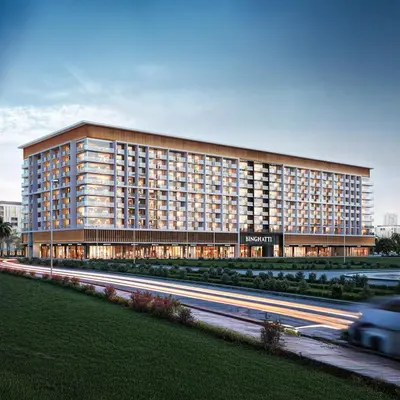 a large building with a road in front of it at Brand new apartment with luxury furniture in JVC in Dubai