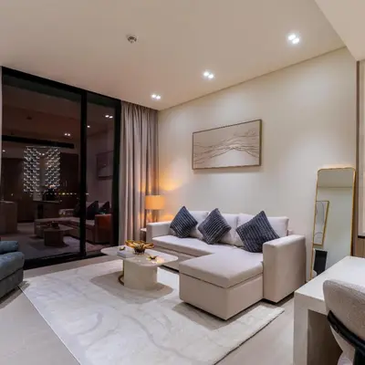 a living room with a couch and a table at Brand new apartment with luxury furniture in JVC in Dubai