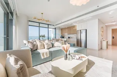 a living room with a couch and a table at Panoramic Sea View, Offering Direct Access to Beach, Three Bedrooms and Assistant Room - Beach Vista Tower 2 by Deluxe Holiday Homes in Dubai