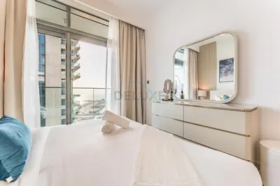 a bedroom with a large mirror and a bed at Panoramic Sea View, Offering Direct Access to Beach, Three Bedrooms and Assistant Room - Beach Vista Tower 2 by Deluxe Holiday Homes in Dubai
