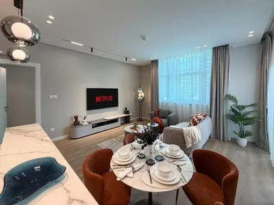 a living room with a table and chairs at Stylish 1 BR with hotel facilities and canal view in Dubai