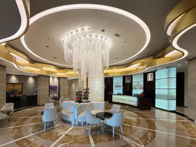 a lobby with a chandelier and a table and chairs at Stylish 1 BR with hotel facilities and canal view in Dubai